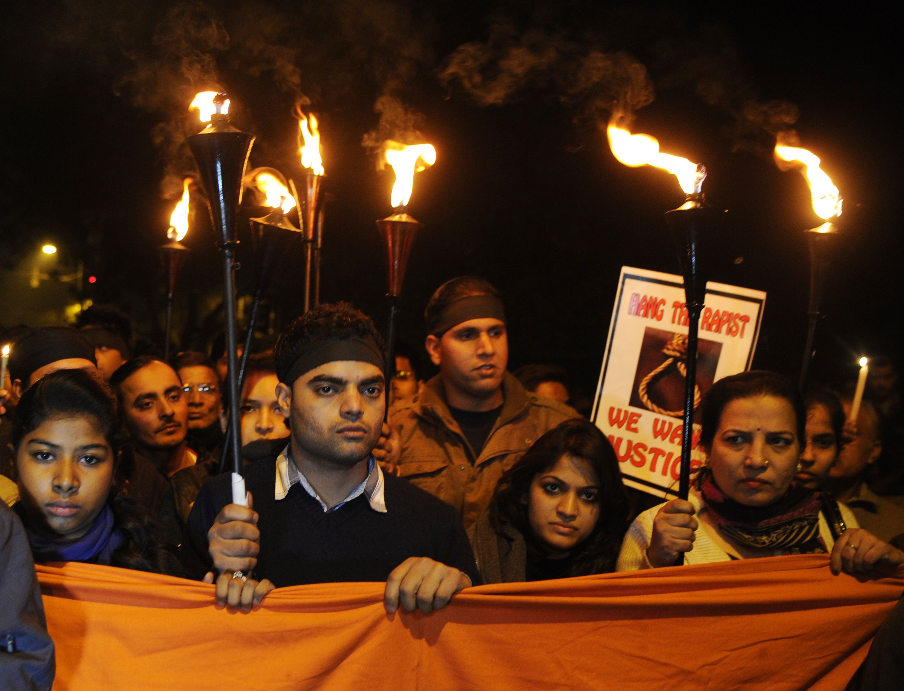 Protesters holding candles in a vigil demanding justice